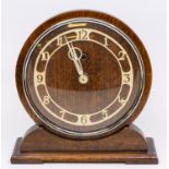 An Art Deco style oak cased mantle clock, with circular face and Temco movement.