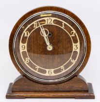 An Art Deco style oak cased mantle clock, with circular face and Temco movement.
