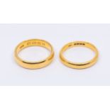 Two 22ct gold bands, width approx 5mm and 3mm, sizes P1/2, and O, weight approx 12.1gms  Further