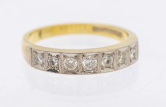 A diamond set 18ct gold half eternity ring, comprising a row of seven small diamonds, platinum