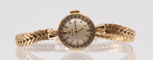 Omega- a ladies vintage 9ct gold wristwatch,  comprising a round signed silvered dial with applied
