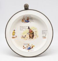 A novelty 20th century ceramic food warmer with scenes and words related to Childrens stories etc,