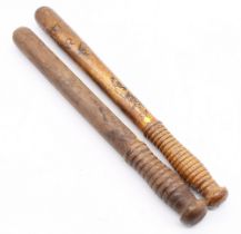 Two Victorian solid oak policeman's truncheons, one plain, other with crown and V.R, 46cm long.