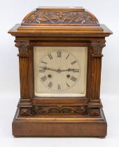 A late 19th Century/early 20th Century 8 day mantle clock, silvered square face with Roman