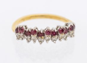 A ruby and diamond gold half eternity ring, comprising a a row of round mixed cut rubies and round