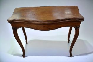 A George III mahogany serpentine games/card table with 20th Century fabric playing top, cabriole