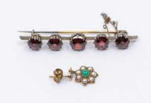A garnet and gilt metal bar brooch, set with five graduated mixed cut garnets, length approx 58mm,