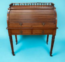 A late Victorian mahogany tambour front writing desk with gallery top, lift up tambour front to