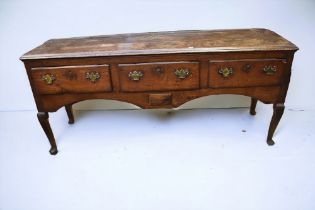 George III solid oak three drawer kitchen dresser on cabriole legs, brass swing handles and