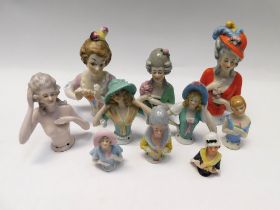 A collection of ceramic early 20th century in cushion dolls in a variety of styles