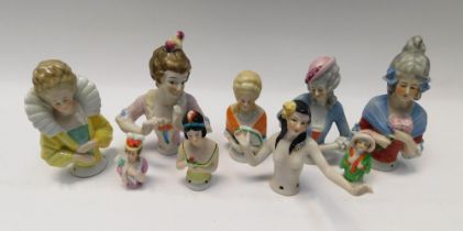 A collection of pin cushion dolls in a variety of styles.