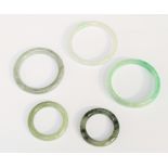 A collection of five Jadeite type children's bangles, in varying sizes, the largest internal