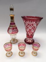 Mid 20th Century red glass continental decanter and three glasses along with a large continental