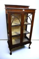 Early 20th Century mahogany display cabinet with fabric internal shelves, glazed to front and sides,