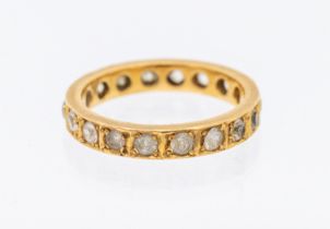 A gold and white sapphire set eternity ring, width approx 3mm, size N1/2, unmarked assessed as