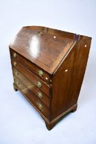 Large George III oak bureau with four graduated drawers, brass swing handles, ox blood writing