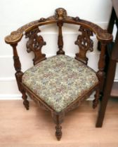 A heavily carved continental corner library chair (c1870) in the Black Forest style, carved eagle