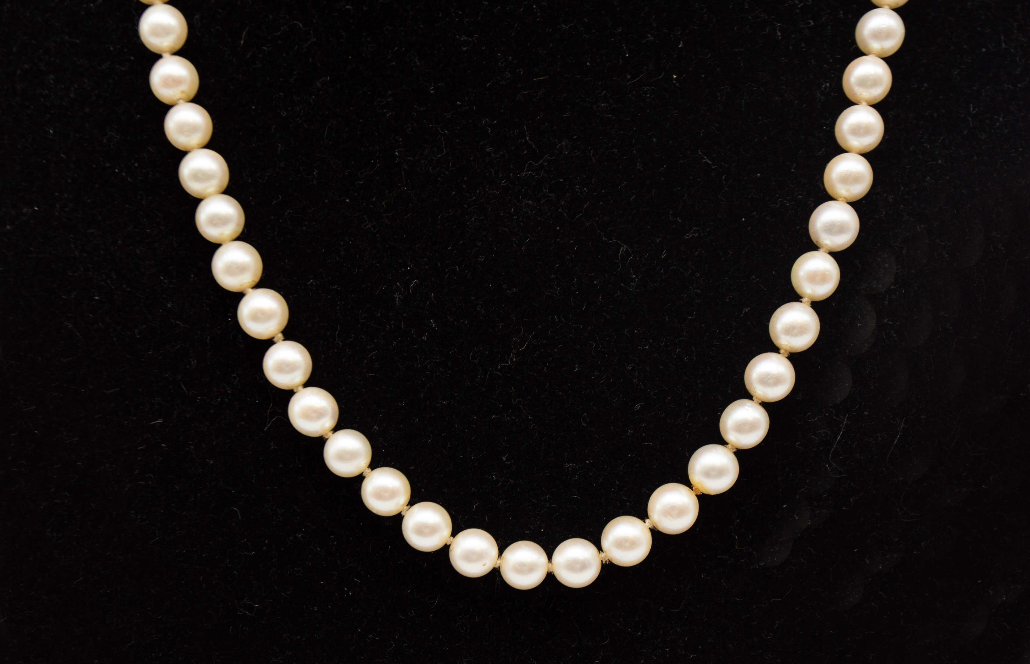 A vintage cultured pearl uniform necklace, each approx 6mm, strung to a white metal and diamond
