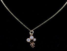 A yellow gold plated pendant and chain, crystal stones in flower design pendant complete with