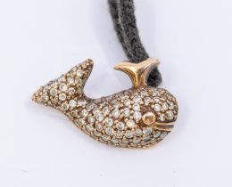 A diamond and pave set whale pendant on black adjustable cord necklet, pendant measures 16x10mm with