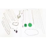 A collection of silver jewellery to include two jadeite pendants one of a carved form, both on