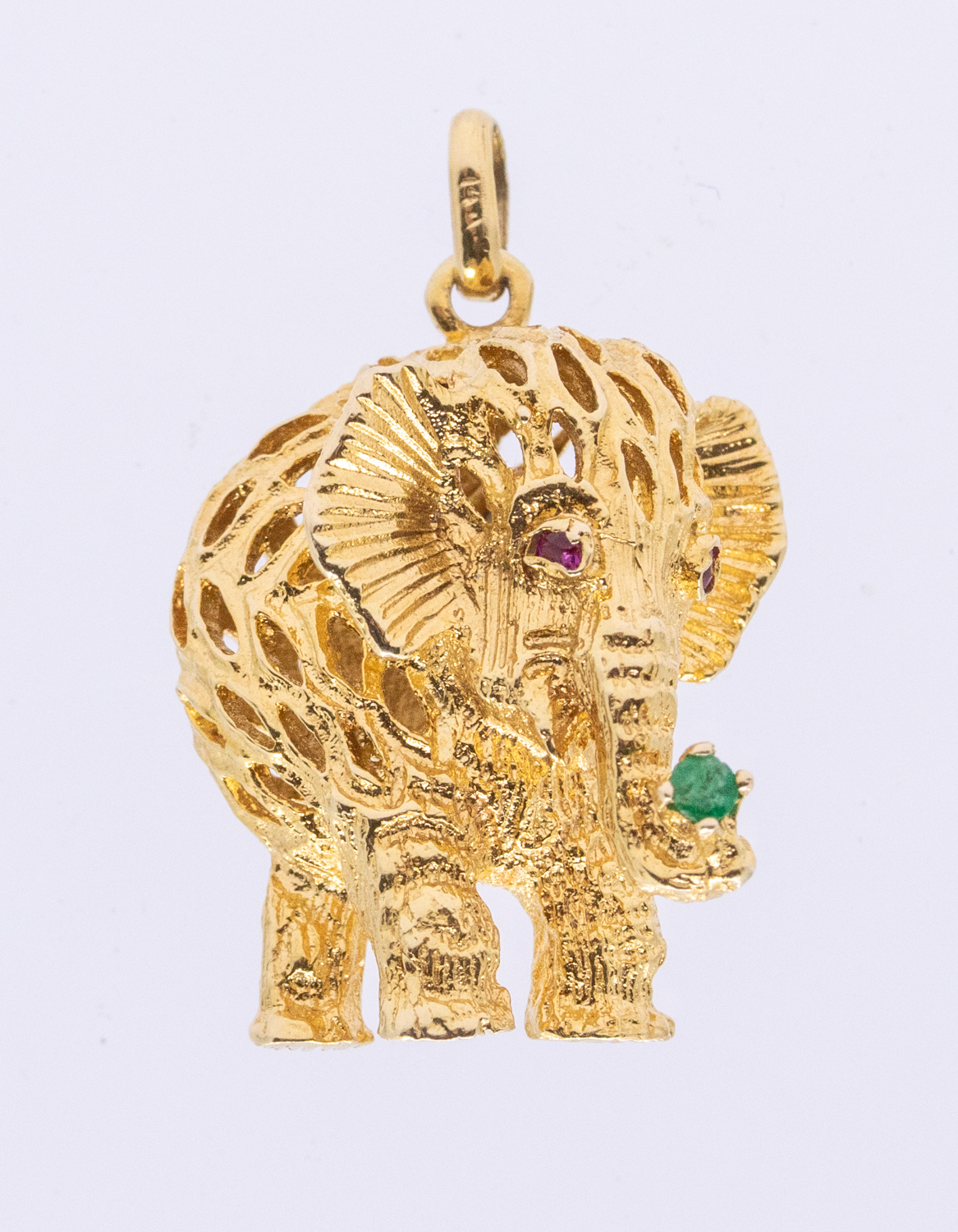 A 14ct gold ruby and emerald set pendant, modeled as an elephant, the eyes set with rubies and the