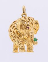 A 14ct gold ruby and emerald set pendant, modeled as an elephant, the eyes set with rubies and the