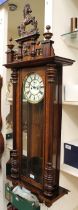 A large veneered wooden-cased Vienna wall clock with stylised horse, mask design, enamel dial and