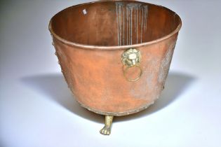 Large 19th Century copper washing tub with lion's head detail, standing on lion's feet.