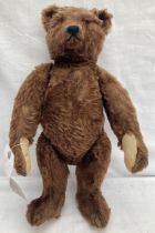 Steiff: An original, circa 1920, Steiff bear with soft curly shaggy brown mohair, glass eyes, four