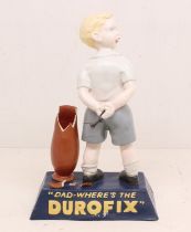 Advertising: A reproduction Durofix, composition shop display figure of a young boy, holding a