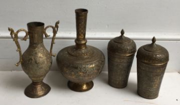 A collection of brass items to include a pair of brass lidded jars and two brass vases. (4)