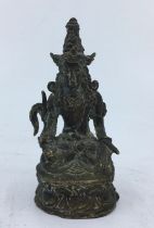 A small Sino-Tibetan bronze figure of a deity.