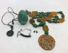 A  jade egg together with jade necklaces and earrings