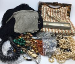 A collection of costume jewellery together with a silver purse, a vintage bag and a vintage shawl.