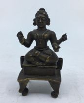 A small Indian bronze figure of a deity.