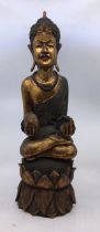 An Asian carved wooden figure of Buddha