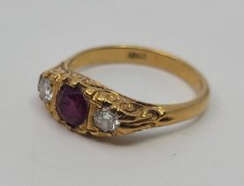 An 18ct. gold, ruby and diamond ring, set central mixed round cut ruby and round brilliant cut