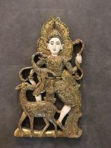 An Asian carved wooden figure of a deity.