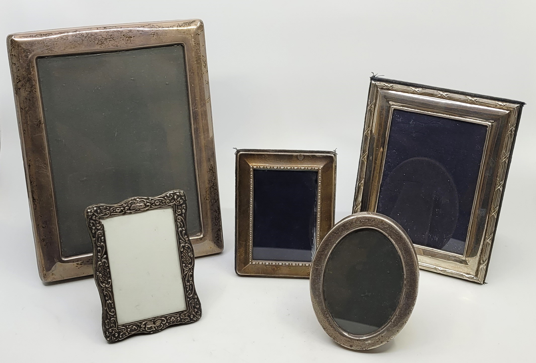 Five various easel back silver photograph frames; the largest by R.Carr Ltd, Sheffield 1992,
