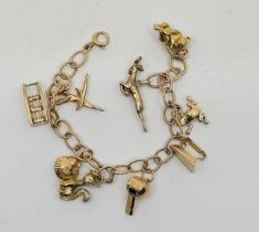 A 9ct. gold charm bracelet, fashioned from textured oval links, suspending nine various charms (6