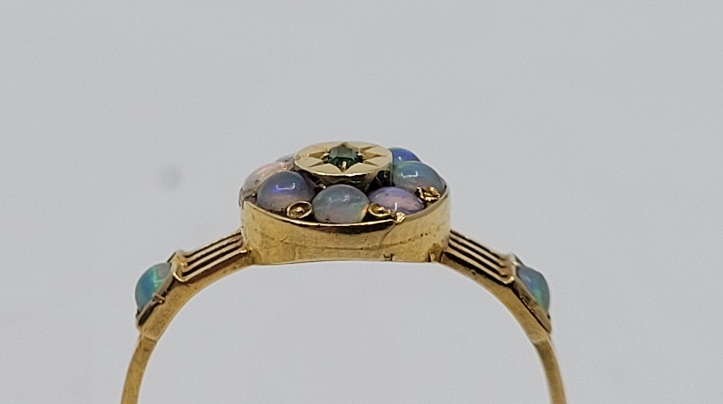 An 18ct gold, emerald and opal ring, the oval mount with raised centre illusion set single - Image 4 of 4
