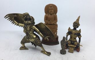 A collection of three Sino-Tibetan/Chinese bronze figures together with a carved wooden figure of