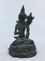 A small Sino-Tibetan bronze figure of a deity.