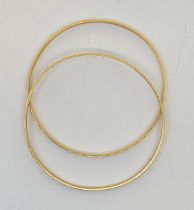 A pair of Indian 22ct. gold bangles, decorated to exterior, external diameter 6.2cm. (total 21.