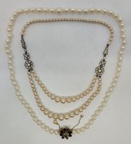 A cultured pearl necklace, with 9ct. gold, pearl and garnet set flower form clasp, length 54cm,