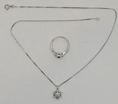 An 18ct. white gold and diamond "snowflake" pendant, set baguette and round brilliant cut