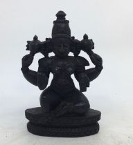 An Indian carved wooden figure of a deity. H:14cm