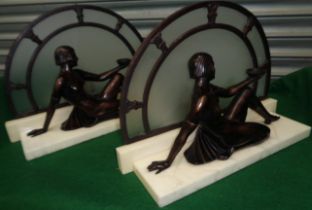 A pair of two Art Deco figures of seated ladies.