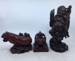 A collection of three Chinese carved wooden figures (3)